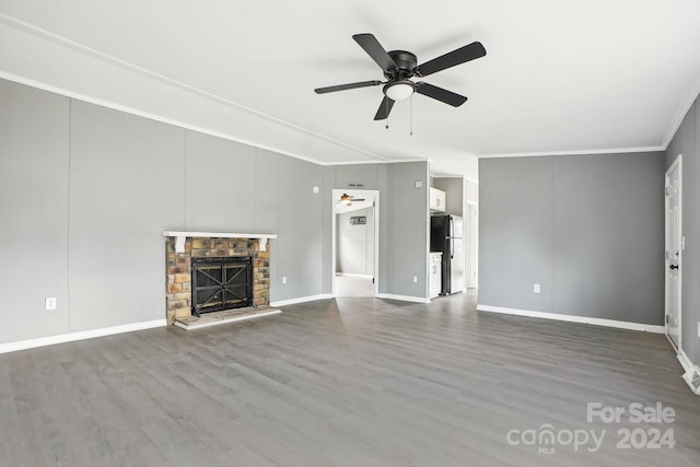 unfurnished living room with hardwood / wood-style floors, ceiling fan, a fireplace, and crown molding