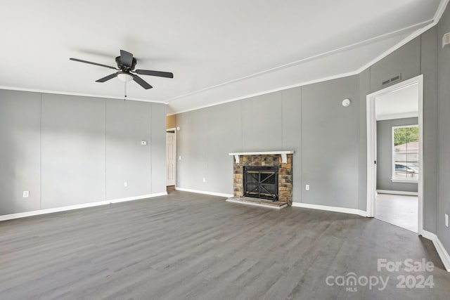 unfurnished living room with crown molding, hardwood / wood-style floors, ceiling fan, and a fireplace