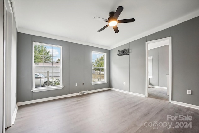 spare room featuring hardwood / wood-style floors, lofted ceiling, ceiling fan, and crown molding