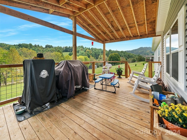 wooden terrace with a mountain view and a grill