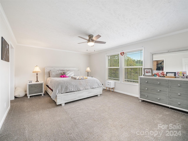 bedroom featuring ornamental molding, ceiling fan, carpet floors, and a textured ceiling