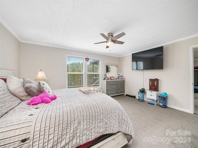 bedroom featuring ceiling fan, a textured ceiling, ornamental molding, and carpet