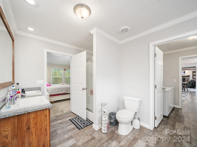 bathroom with wood-type flooring, ornamental molding, toilet, and vanity