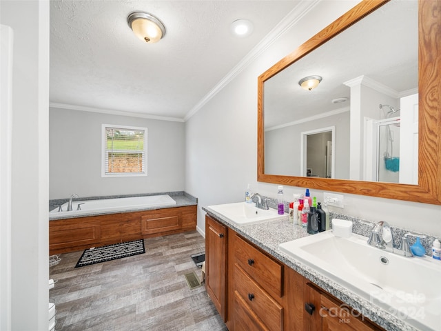 bathroom featuring independent shower and bath, wood-type flooring, vanity, and ornamental molding