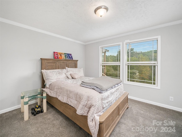 carpeted bedroom featuring ornamental molding and a textured ceiling