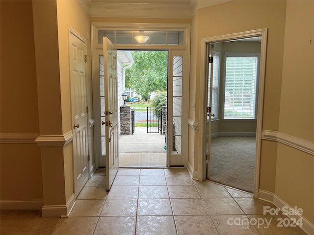 doorway to outside featuring light carpet, a wealth of natural light, and crown molding