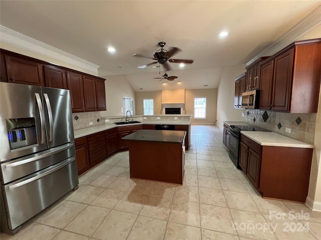 kitchen with tasteful backsplash, sink, kitchen peninsula, stainless steel appliances, and ornamental molding