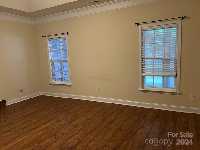 unfurnished room featuring ornamental molding, dark hardwood / wood-style floors, and a healthy amount of sunlight