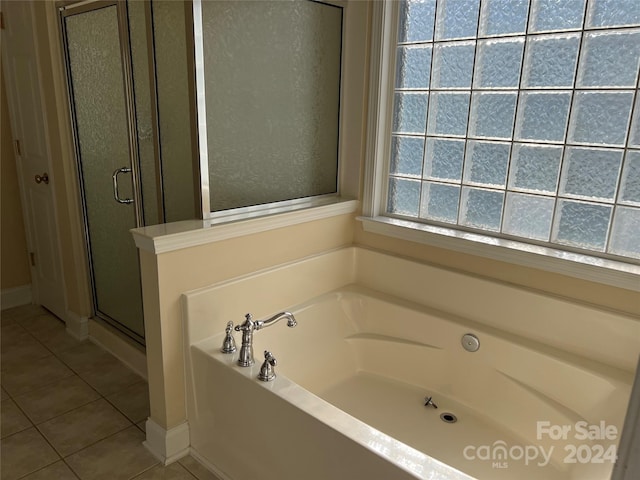 bathroom with tile patterned floors and separate shower and tub