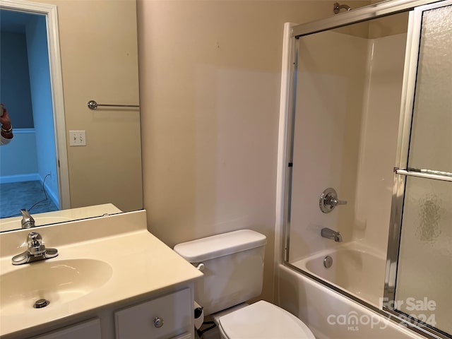 full bathroom featuring vanity, toilet, and combined bath / shower with glass door