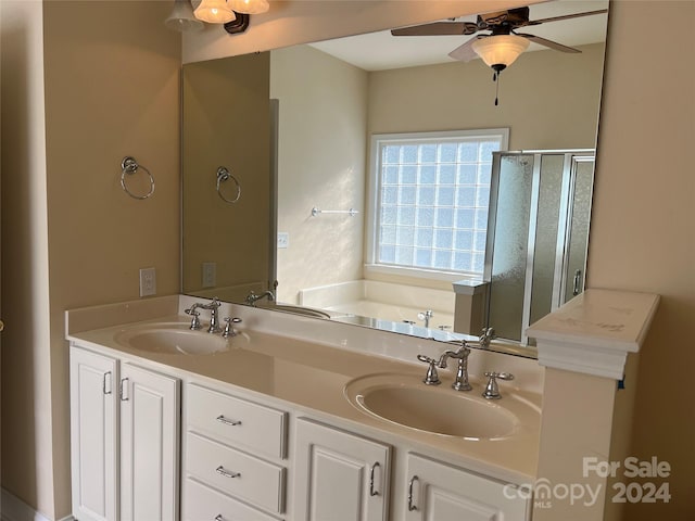 bathroom featuring independent shower and bath, vanity, and ceiling fan