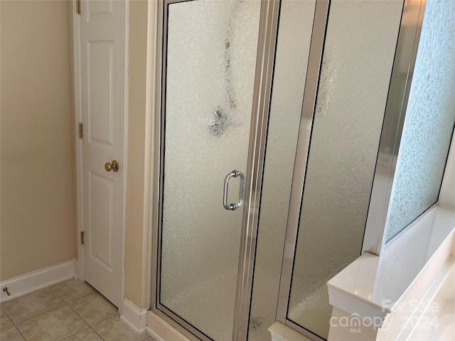 bathroom featuring tile patterned flooring and walk in shower