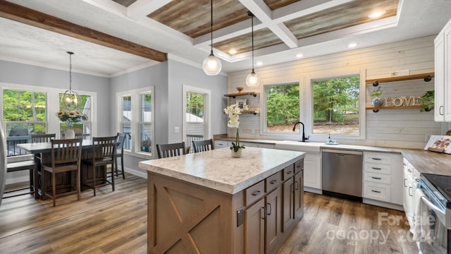 kitchen with appliances with stainless steel finishes, plenty of natural light, and white cabinetry