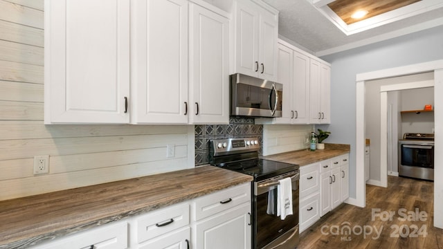 kitchen featuring dark hardwood / wood-style flooring, stainless steel appliances, and white cabinets