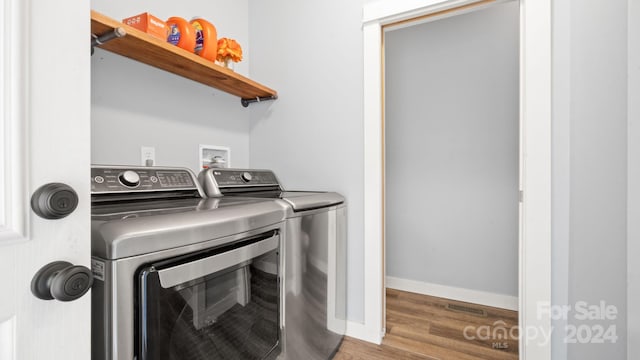 laundry area featuring wood-type flooring and washer and dryer