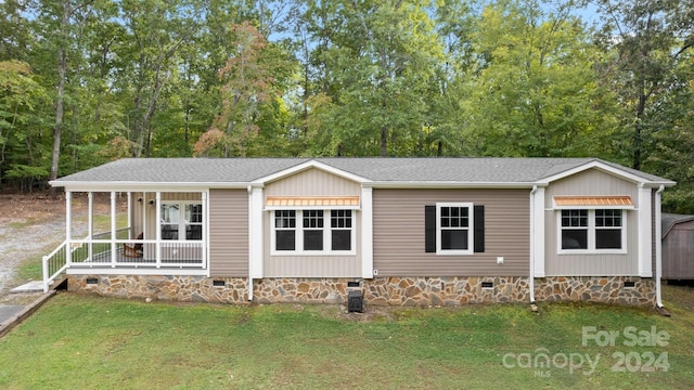 view of front of home with a front yard and a porch