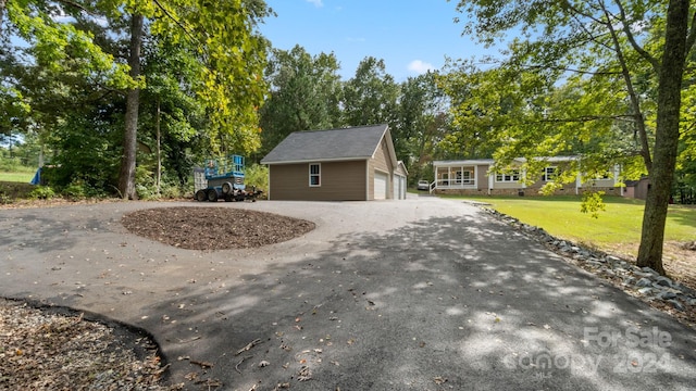 view of side of property with a yard and a garage