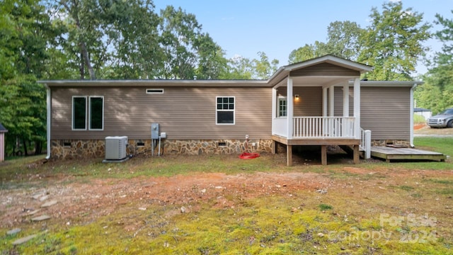 rear view of property with central AC and a deck