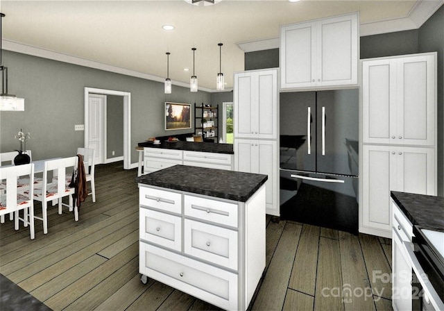 kitchen with fridge, a kitchen island, pendant lighting, and white cabinets