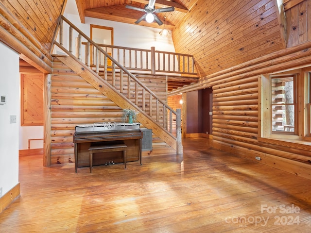 stairway featuring wood-type flooring, wood ceiling, ceiling fan, and high vaulted ceiling