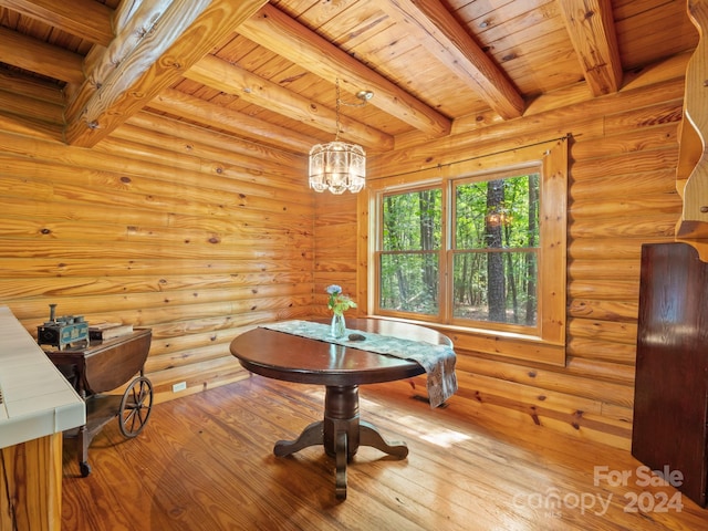 dining space featuring beamed ceiling, rustic walls, light hardwood / wood-style floors, and wooden ceiling