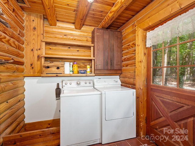 laundry area with wood ceiling, independent washer and dryer, rustic walls, and cabinets