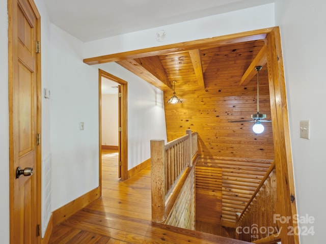 stairs with wooden ceiling, ceiling fan, and hardwood / wood-style flooring