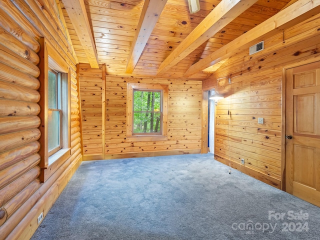 carpeted spare room featuring beamed ceiling, wooden ceiling, and log walls