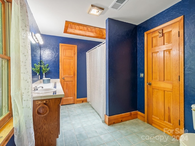 bathroom featuring vanity, toilet, and tile patterned floors