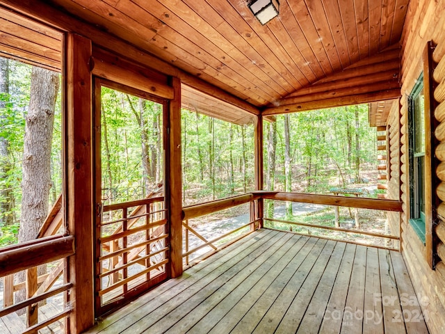 unfurnished sunroom with lofted ceiling and wooden ceiling