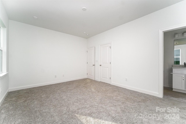 unfurnished bedroom featuring light colored carpet