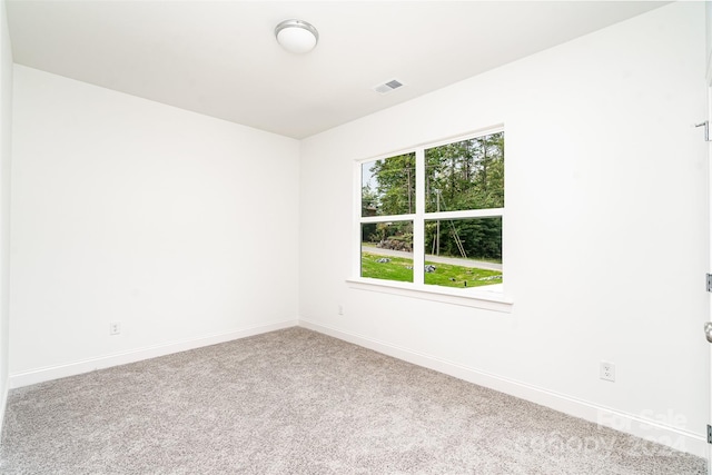 unfurnished room featuring light colored carpet