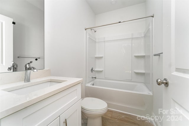 full bathroom with hardwood / wood-style floors, vanity, toilet, and shower / bathtub combination