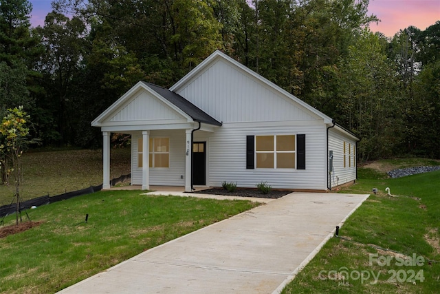 view of front of property with a lawn and covered porch