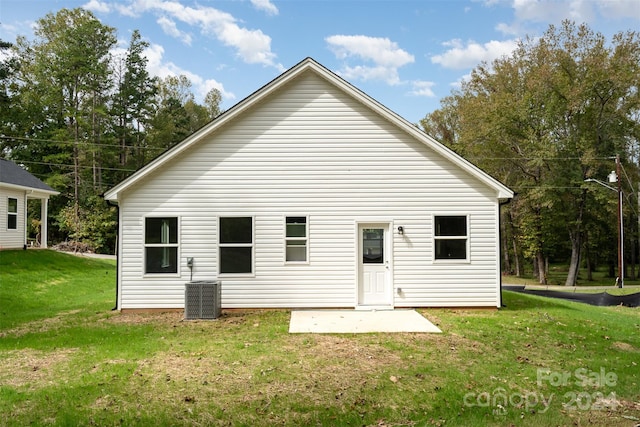 back of property featuring a yard