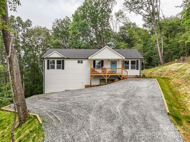 376 Hague Dr, Columbus, NC 28722 - ranch-style house featuring gravel driveway, roof with shingles, and covered porch