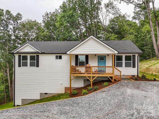 376 Hague Dr, Columbus, NC 28722 - ranch-style house with crawl space, covered porch, roof with shingles, and view of wooded area