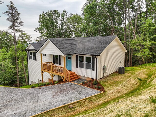 376 Hague Dr, Columbus, NC 28722 - view of front of house with crawl space, a shingled roof, a front yard, covered porch, and central AC unit