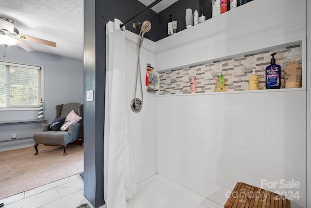 bathroom with curtained shower, tile patterned floors, a textured ceiling, and ceiling fan