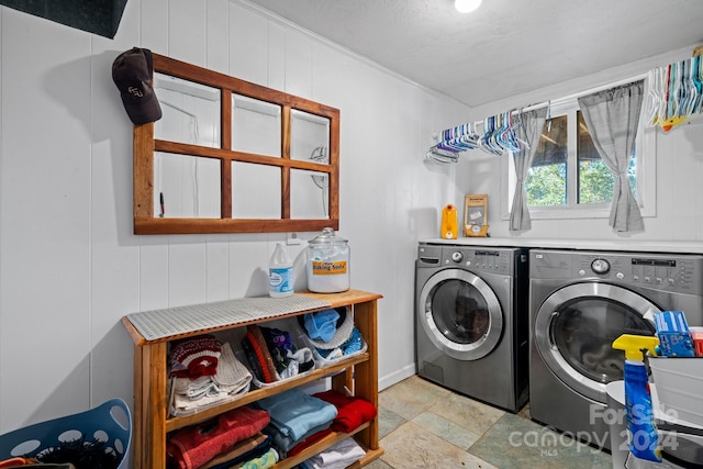 washroom with wooden walls and independent washer and dryer