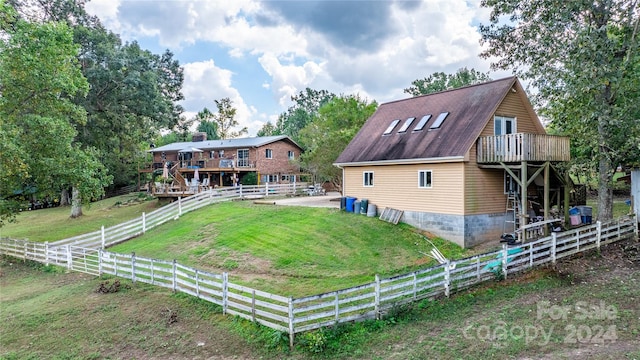 back of house with a lawn and a deck