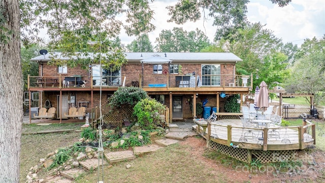 rear view of house featuring a wooden deck