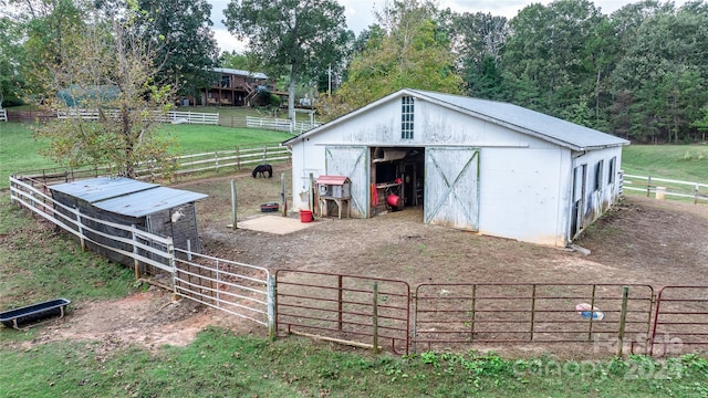 view of horse barn with a rural view