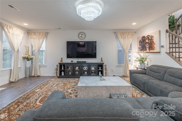 living room with hardwood / wood-style flooring and a chandelier