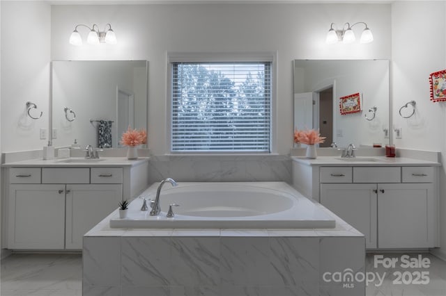 bathroom featuring vanity and a relaxing tiled tub