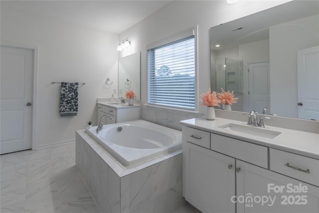 bathroom featuring vanity and independent shower and bath