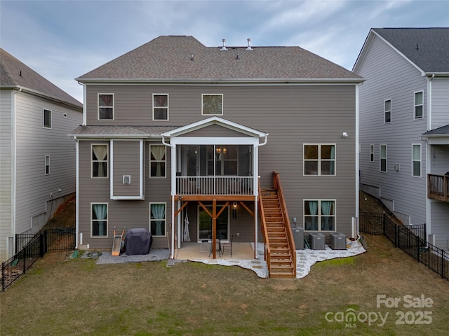 rear view of house with central AC unit, a sunroom, a yard, and a patio