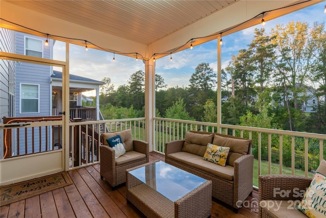 wooden terrace with an outdoor hangout area