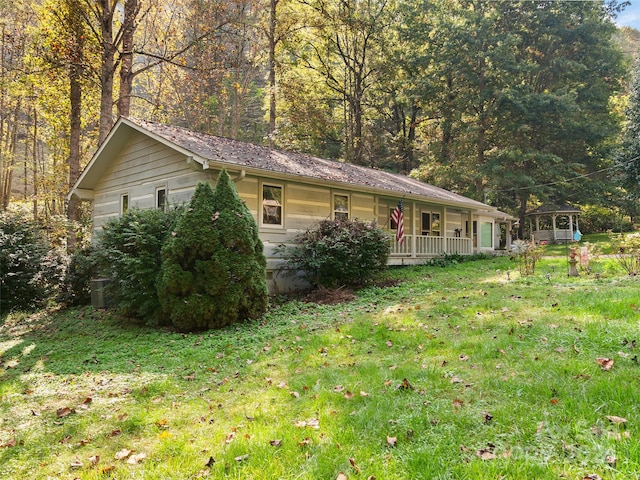 view of home's exterior with a porch and a yard