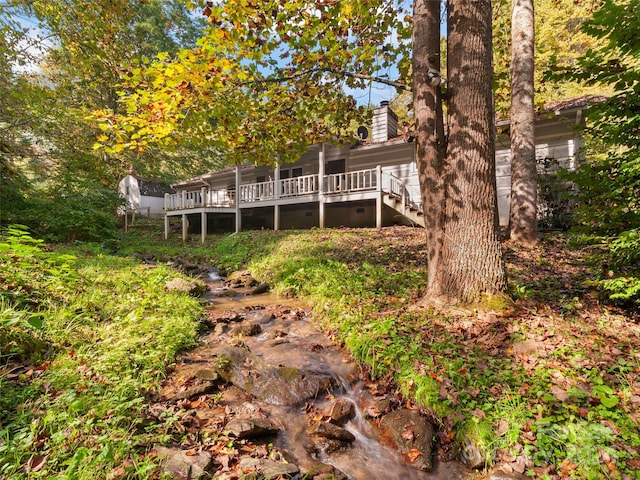 back of property featuring a wooden deck